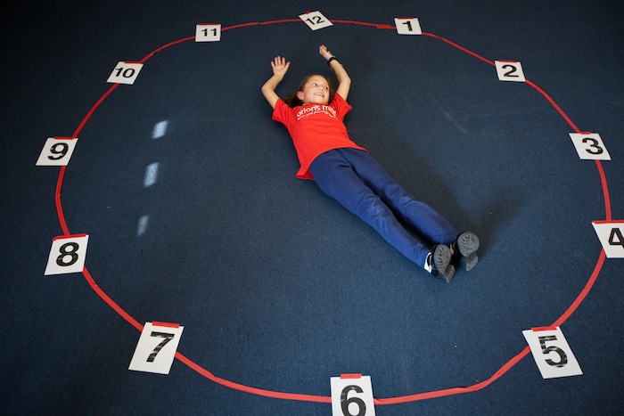 Students learn to tell time in an activity called Human Clock.